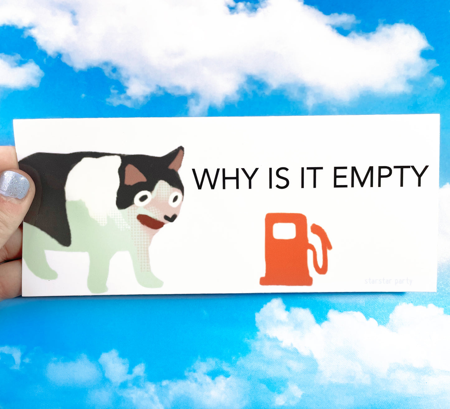 A hand holds a bumper sticker in front of a sky-print background. The sticker features a cat making a silly gasping face. To the right of the cat is a red "empty gas" signal. The text on the sticker reads, "WHY IS IT EMPTY".
