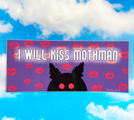 A bumper sticker sits on a sky print background. The bumper sticker features a purple background with hot pink kiss marks all over it. In the center bottom of the sticker is a black silhouette of mothman with hot pink eyes. The text on the sticker reads, "I will kiss Mothman".
